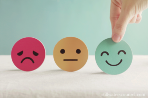 Three circles representing a red sad face, yellow neutral face, and green happy face