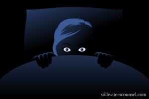 Drawing of person scared hiding under the covers in black, white, and blue hues